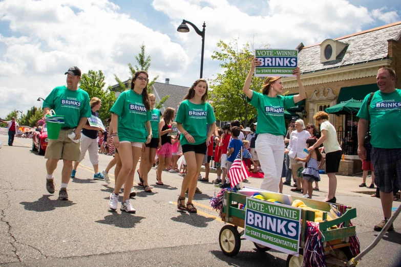 a parade with people walking down the road