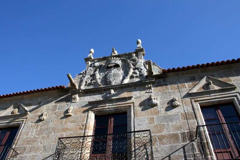 an old building with stone work and two balconies