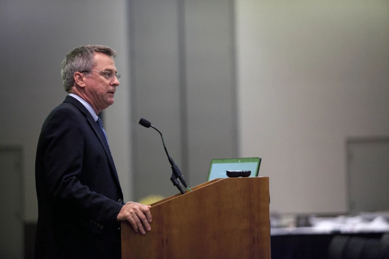 a man giving a speech at a podium