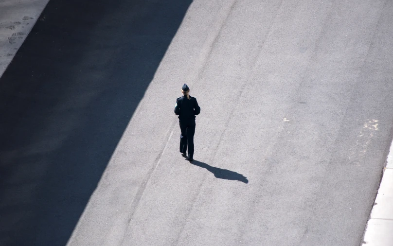 a person that is standing in the middle of a street