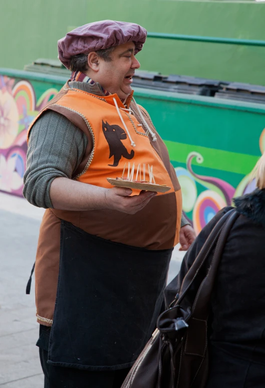 a woman in an orange vest carrying a purse and some people