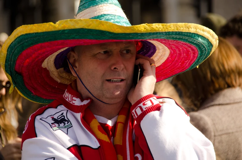 a man in a sombrero talking on the phone