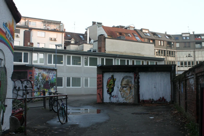 an old building with graffiti and bicycles parked