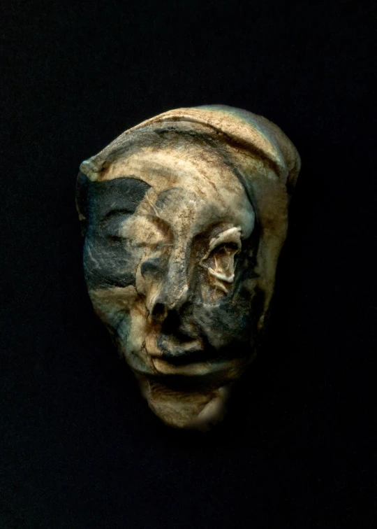 there is an old clay head on display