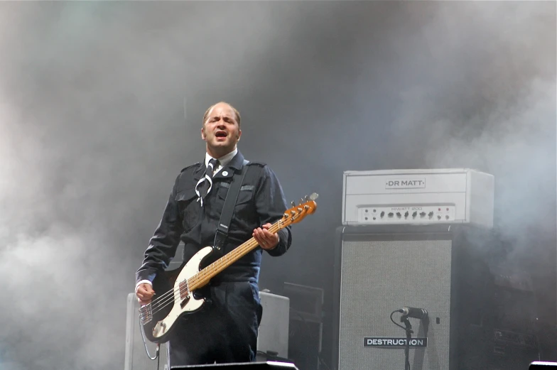 a man that is holding some kind of guitar