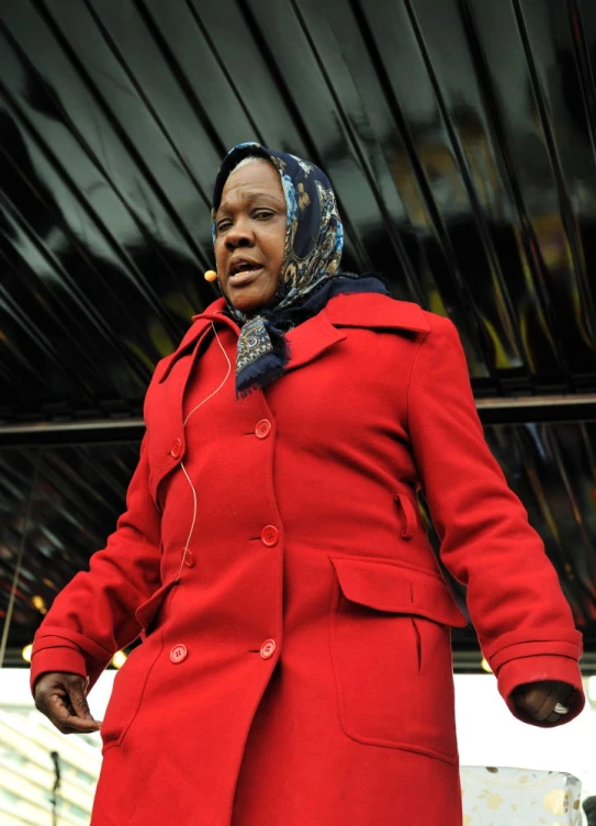 a woman in a red coat is outside