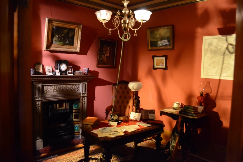 a room with an old fireplace and red walls