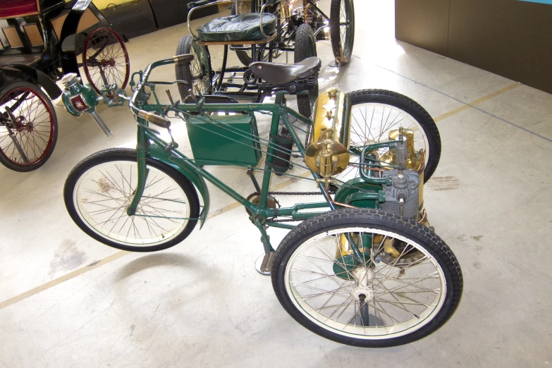 a car sitting on display with different kinds of bikes