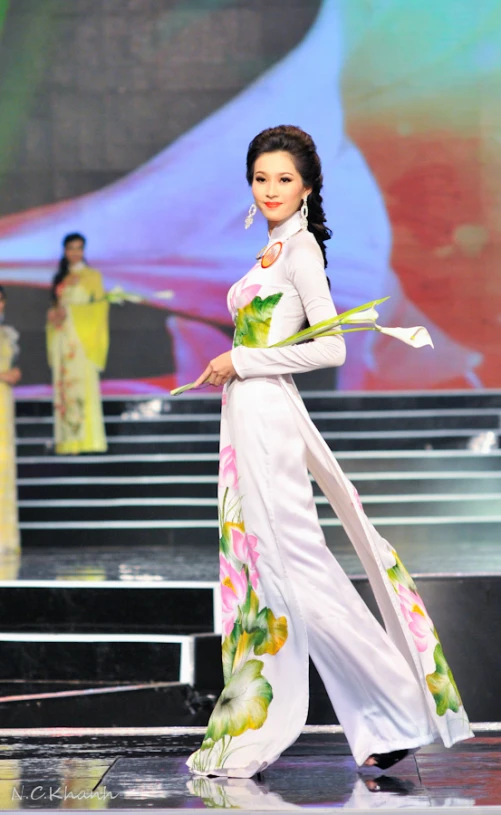 a model walking on the runway wearing floral dress