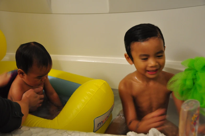 two boys in the bathroom with toys and toys