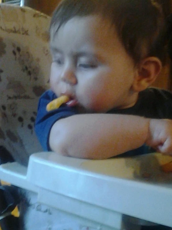 a toddler eating at a high chair
