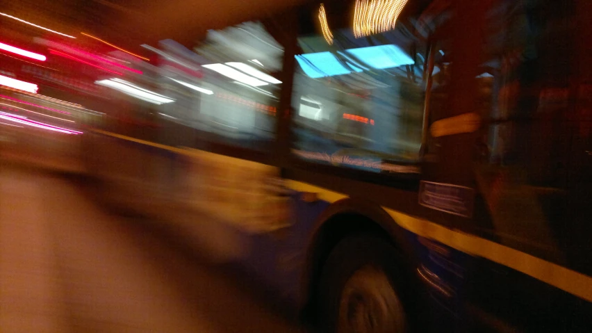 a long time exposure picture of a bus on the street at night