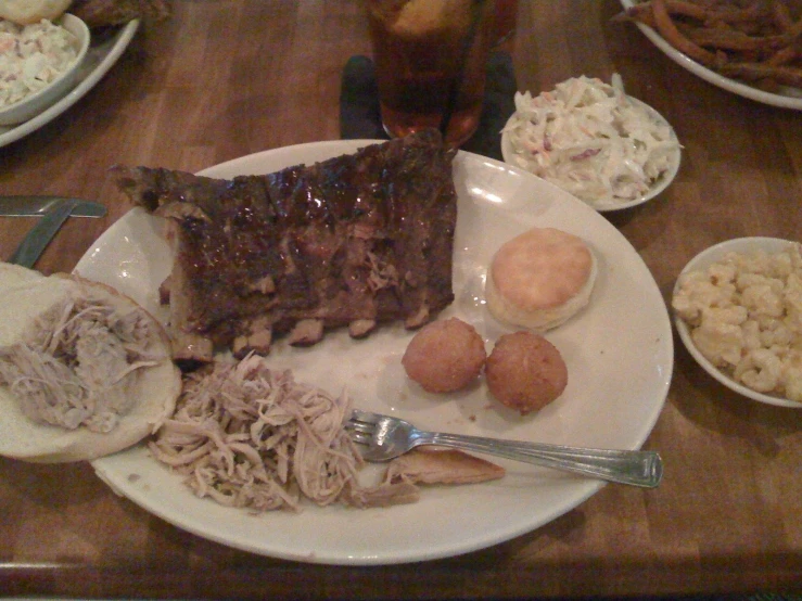 a plate topped with meat and vegetables on top of a table