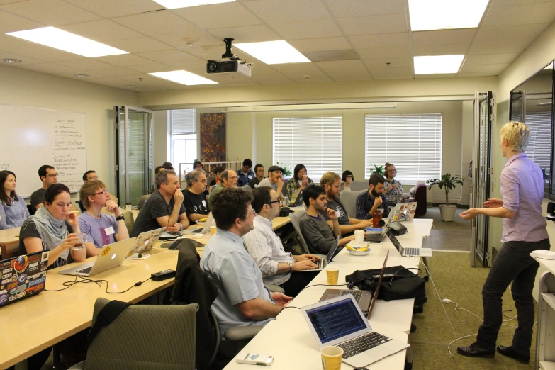 a group of people are sitting in a conference room