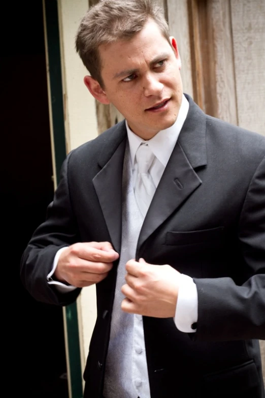 man in suit getting ready to go into a room