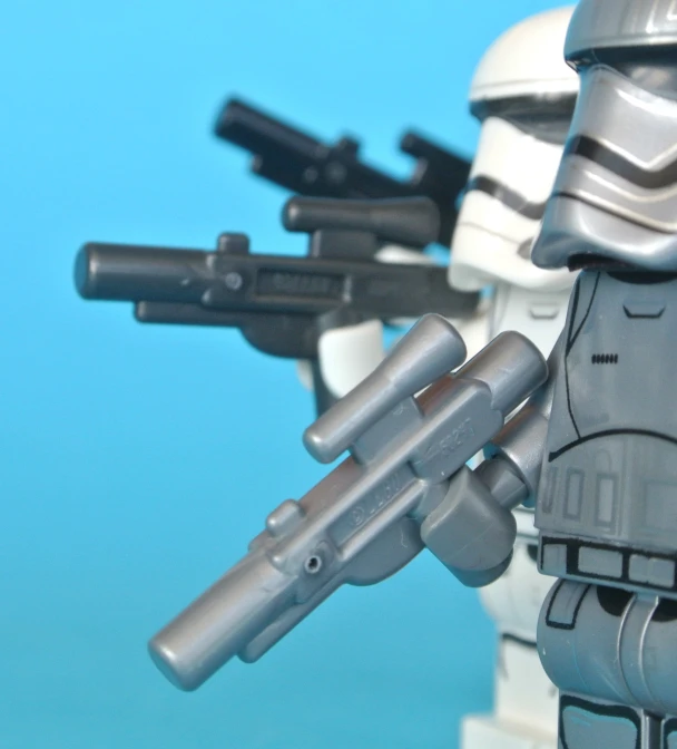 a lego star wars toy holding two guns