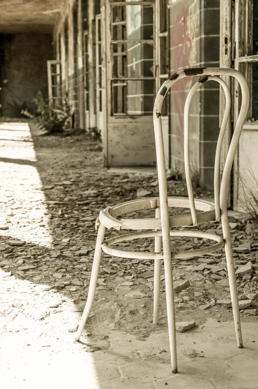 an old chair sitting outside an abandoned building