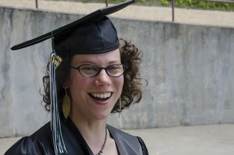 a woman wearing a graduation hat with glasses