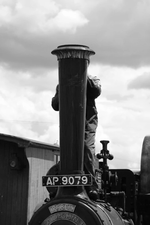 a black and white po of a man leaning on the train