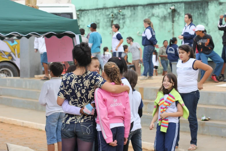 a bunch of children congregate in the street