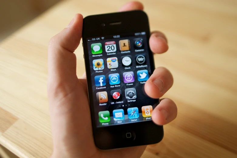 a man holding a black iphone in his hands