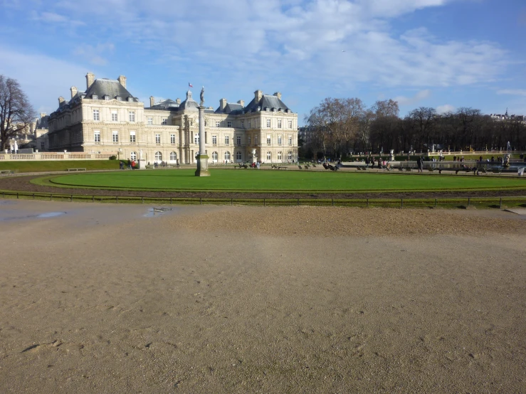 a huge white building sits in the middle of a park