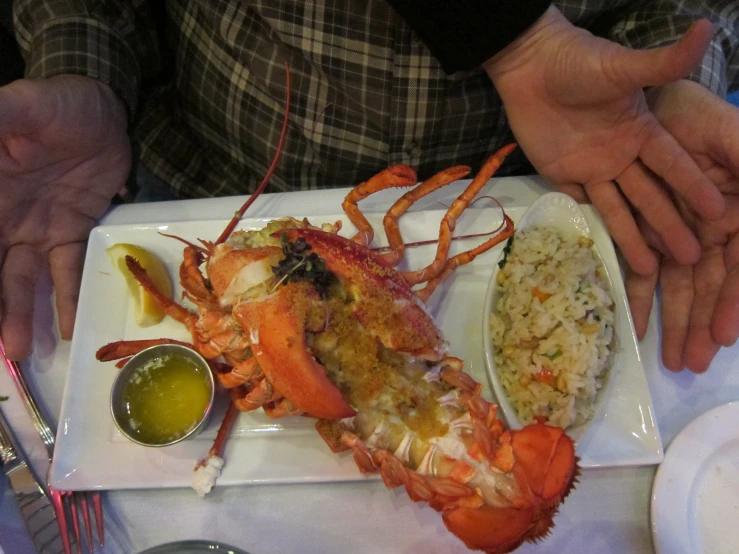 a seafood platter and rice with sauces and spoons next to it