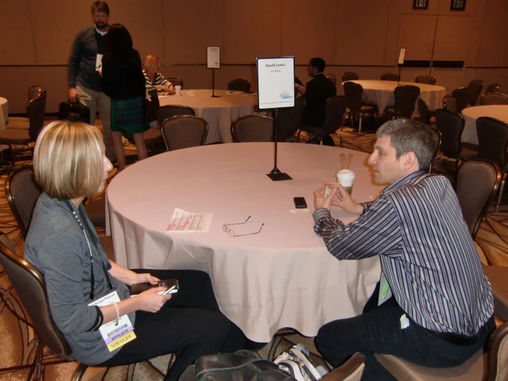 a group of people sitting around a table having a conversation