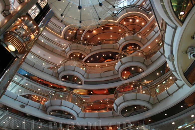 a large circular building with an escalator and stairway