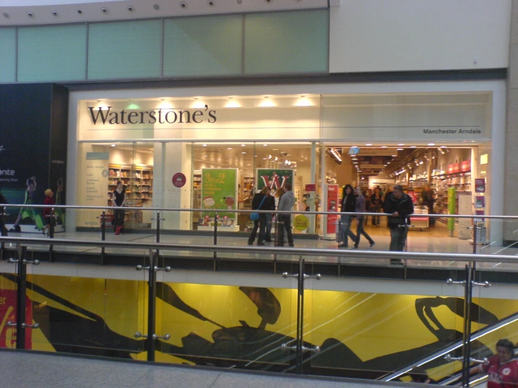 people walking up and down the stairs to a store