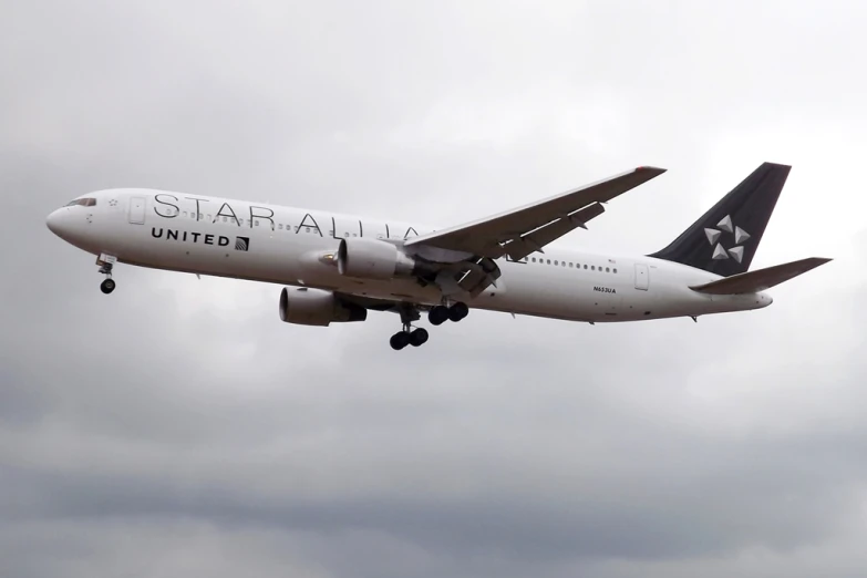 a large jetliner flying through a cloudy sky