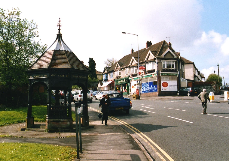 a group of people riding bicycles near a gazebo and street