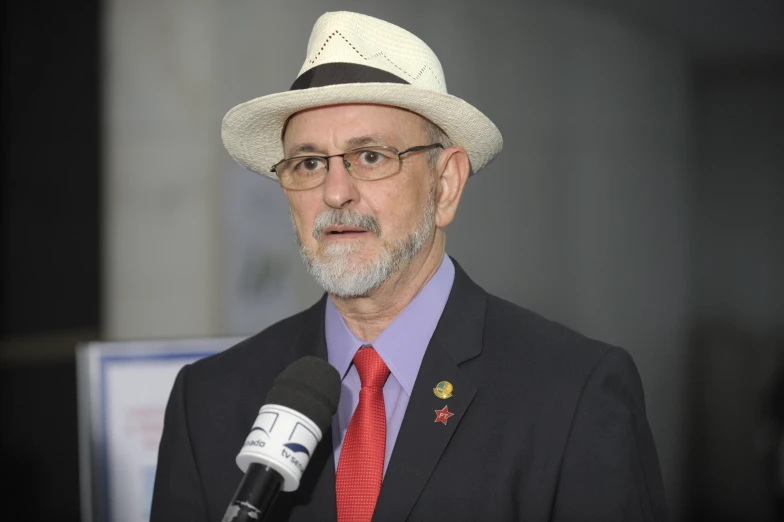 the older man is wearing a red tie