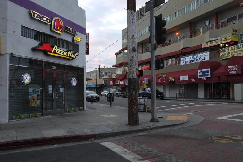 a city street has buildings on both sides and people walking by