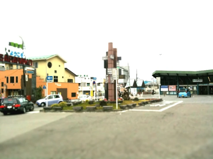 cars drive down a road next to an intersection