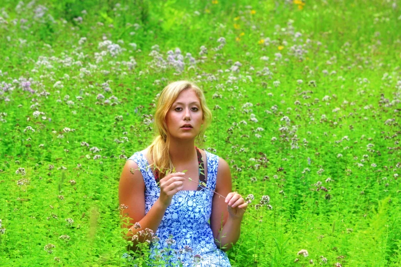 a woman in a flower field wearing sandals