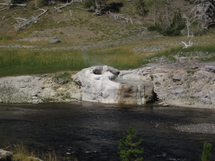 there is a very large rock sticking out of the water