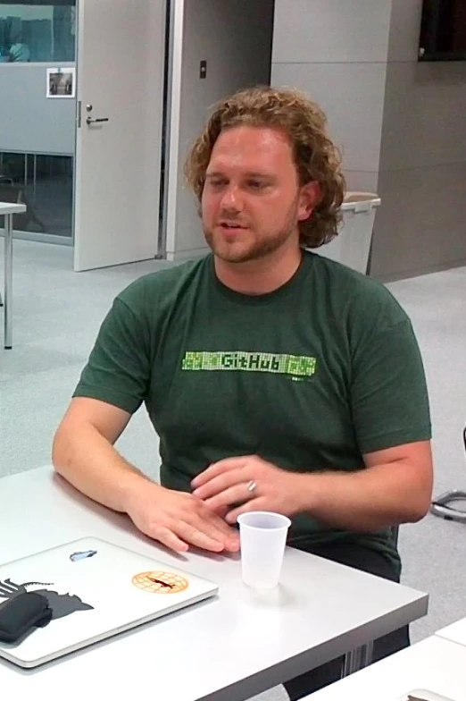 a man sitting at a table in an office