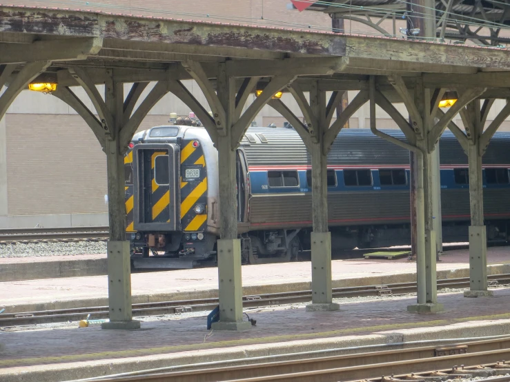 two trains passing under an overpass near one another