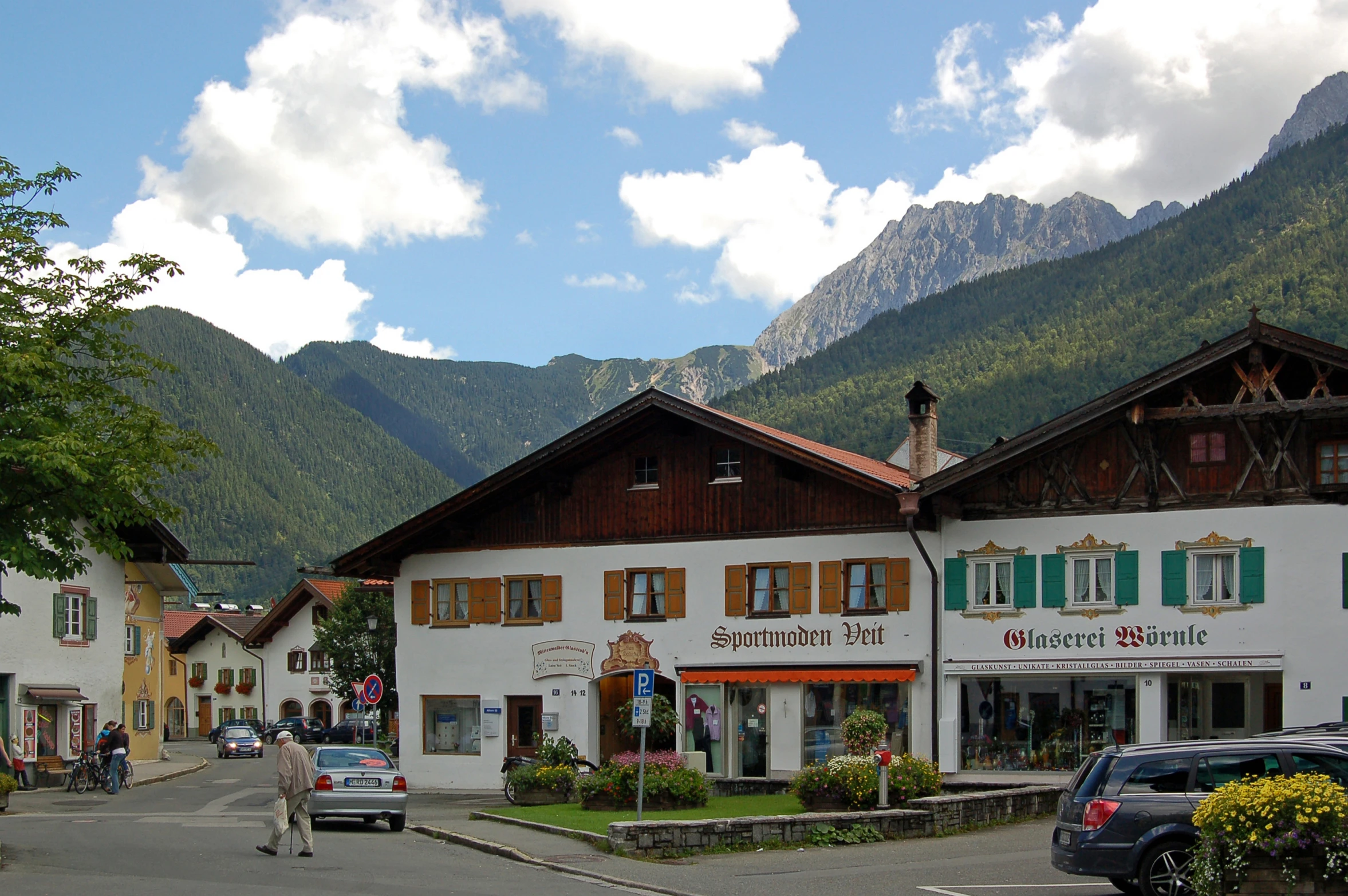 a town with some cars parked near a mountain