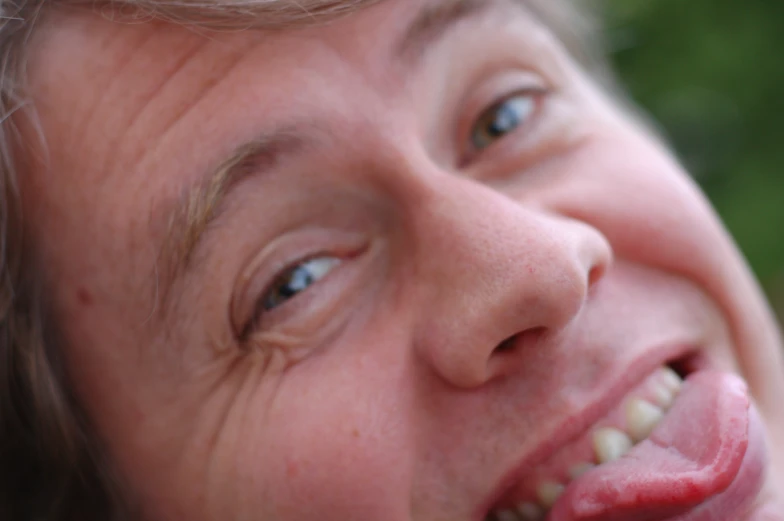 a young person holding a toothbrush up to their teeth