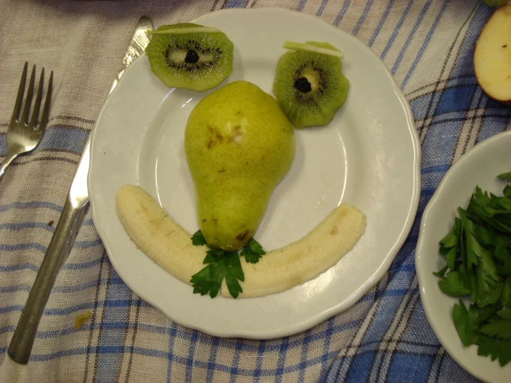 a plate is decorated with fruits and vegetables