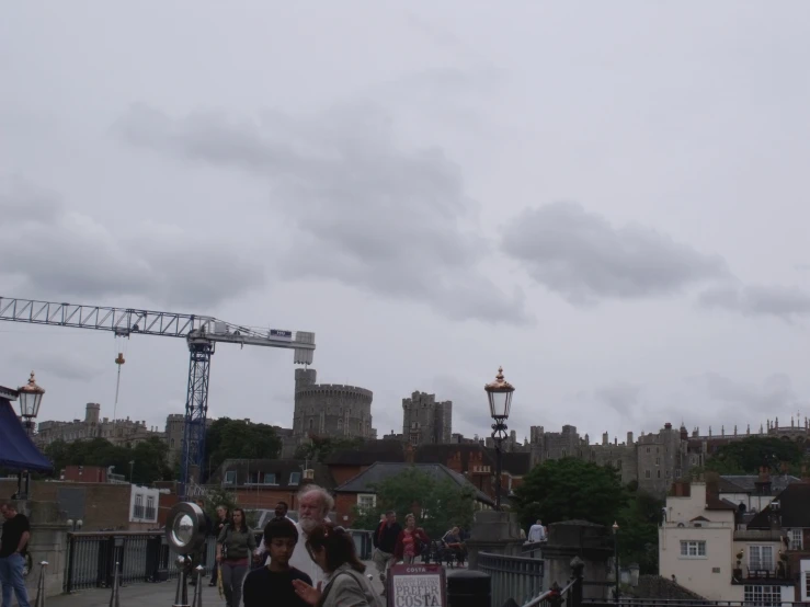 a crowd of people are standing outside and some buildings