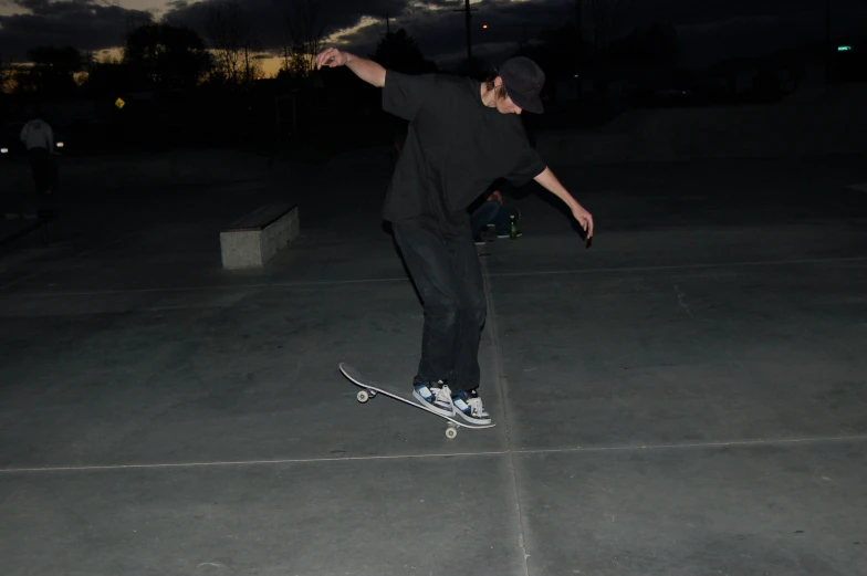 the man is balancing on his skateboard outside