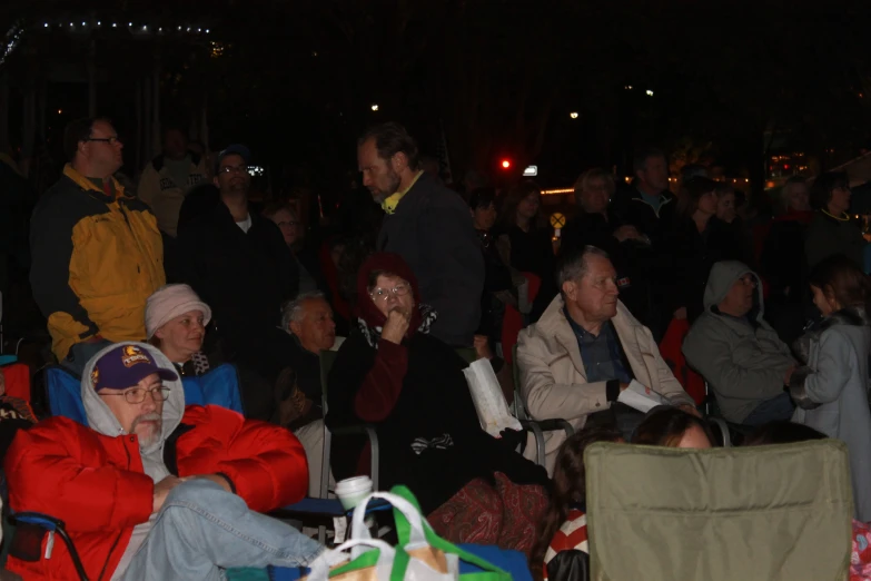 some people sitting together in chairs with lights on the side