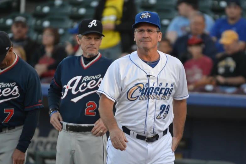 two professional baseball players are talking on the field