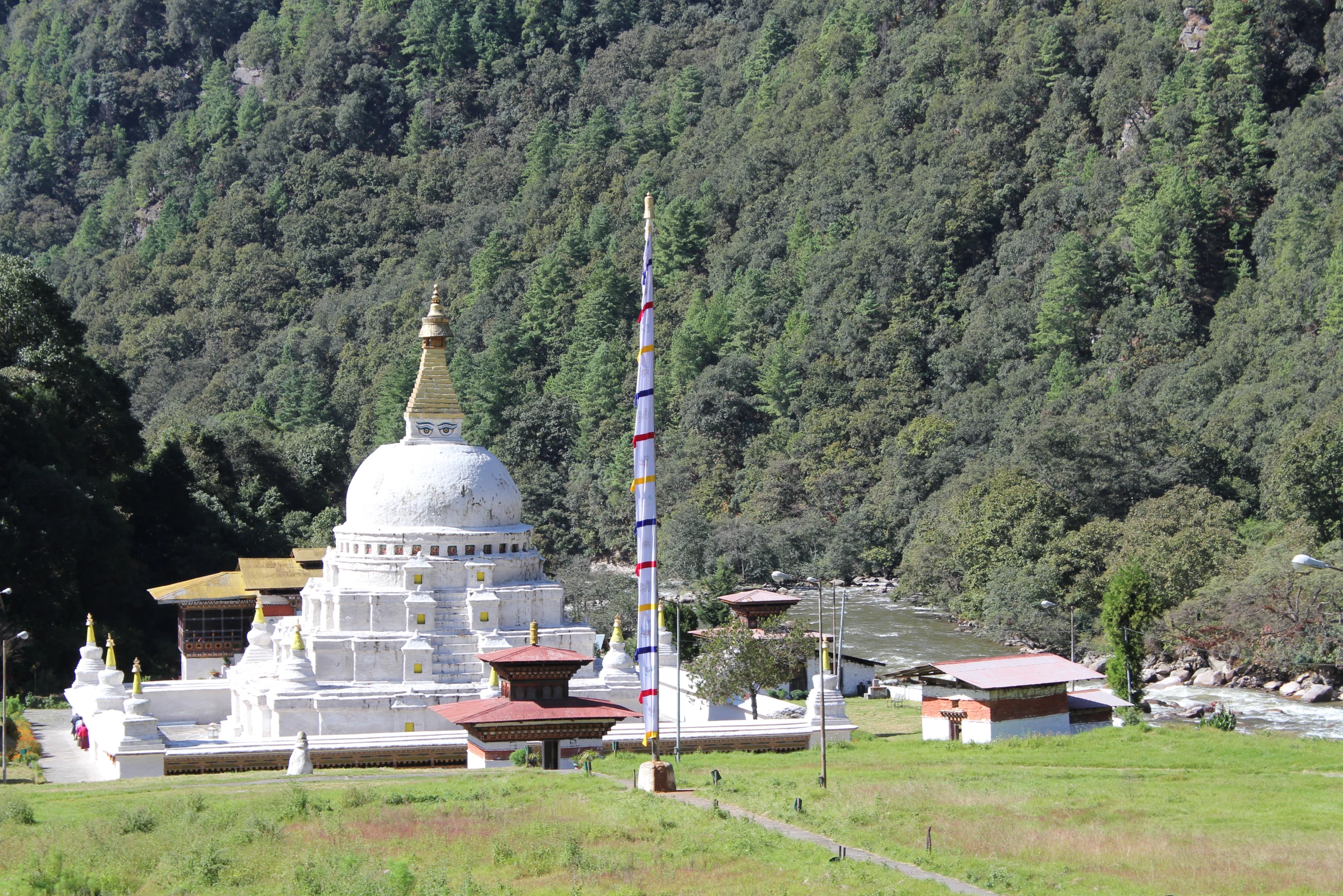 the big white and gold building stands in front of the valley