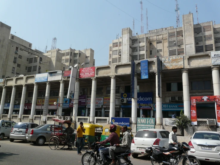 a row of shops and people standing in front of them