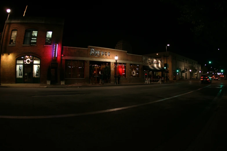 a large street with some very lit up shops