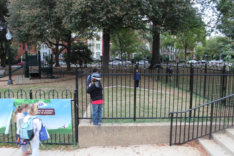 children are taking pictures in an empty park